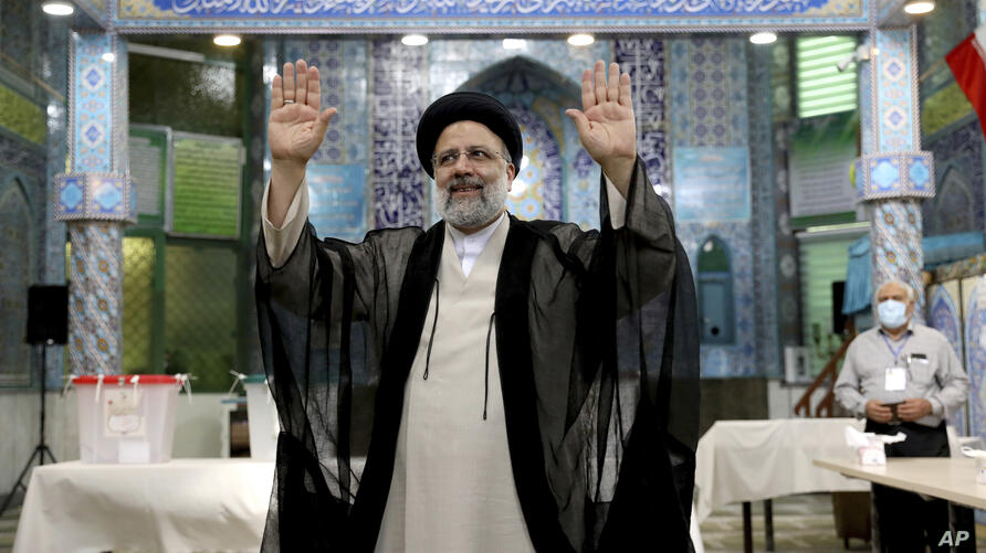 APTOPIX Iran Elections - Ebrahim Raisi a candidate in Iran's presidential elections waves to the media after casting his vote at a polling station in Tehran, Iran Friday, June 18, 2021. Iran began voting Friday in a presidential election tipped in the favor of a hard-line protege by mohsen dehbashi