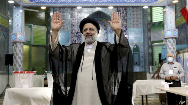 APTOPIX Iran Elections - Ebrahim Raisi a candidate in Iran's presidential elections waves to the media after casting his vote at a polling station in Tehran, Iran Friday, June 18, 2021. Iran began voting Friday in a presidential election tipped in the favor of a hard-line protege